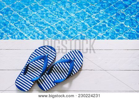 Blue Flip-flops On The Swimming Pool Background