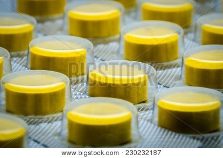 Macro Shot Detail Of Yellow Tablets Pill In Blister Pack. Full Frame Of Tablet Pills
