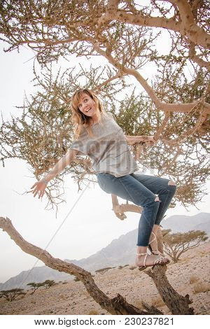 Pretty Girl Have Fun On A Tree In The Desert In A Day