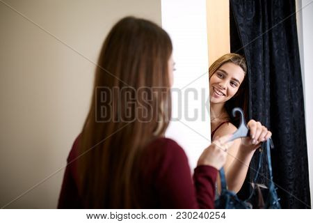 Beautiful Young Woman Asking For A Friends Opinion In The Fitting Room Of Lingerie Store. Female Tri