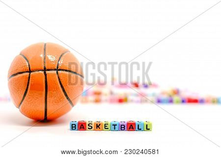 Basketball Word From Alphabet Letter Beads And Blurred Colourful Cubes On White Background For Sport