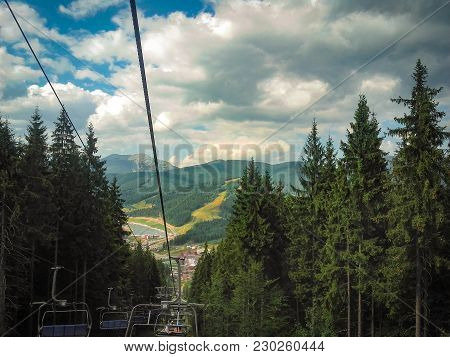 Mountain Lift In Carpathian Mountains. Summer. Cloudy Sky And Green Trees