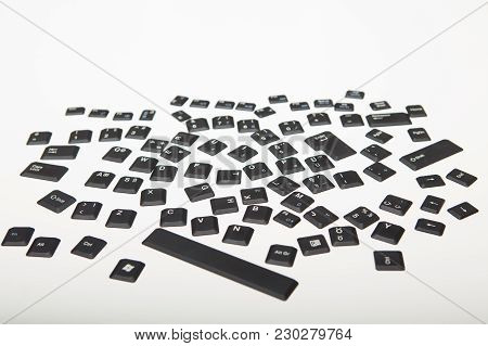 Loose Alphanumeric Covers For The Keys On A Computer Keyboard In A Random Jumble On A White Or Light