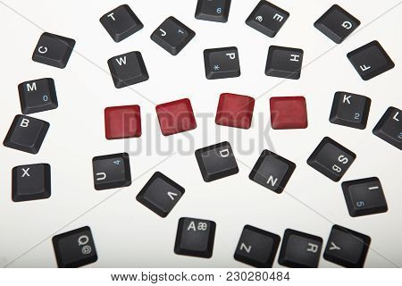 Overhead View Of A Composed  Alphanumeric Computer Keyboard With Four Blank Red Keys On Silver Gradi