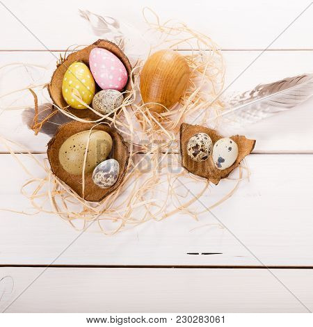 Easter Background With Easter Eggs, Bird Feather And Spring Flowers. Top View With Copy Space