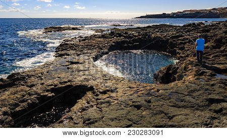 Angler On El Bufadero, Rocky Seashore On Gran Canaria Island, Spain.