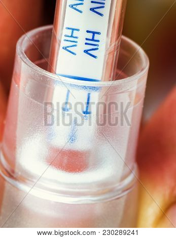 A Hand Holding An Hiv Self-test With Blood Inside On Vintage Effect