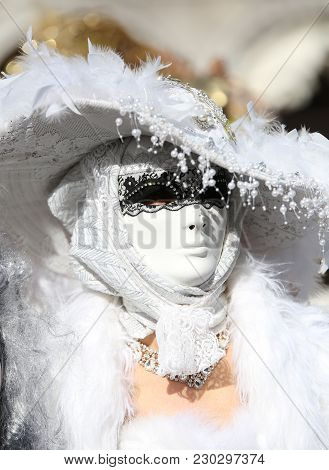 Venice, Italy - February 5, 2018: Woman In White Costume With White Carnival Mask
