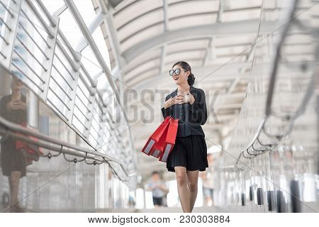 Attractive And Exusive Business Woman Wearing Modern Sunglass With Lot Of Red Shopping Bags. Happy A