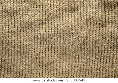 Knit Texture of Beige Wool Knitted Fabric with Regular Pattern. Knit Sweater Blank Background
