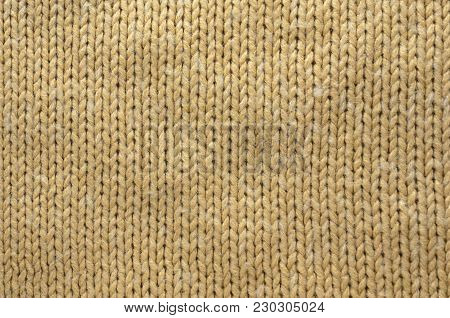 Knit Texture of Beige Wool Knitted Fabric with Regular Pattern. Knit Sweater Blank Background