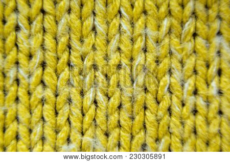 Yellow Knit Texture Close-Up. Knit Sweater Blank Background