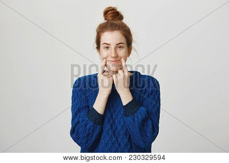 Girl Tries To Pretend She Is Happy In Front Of People. Indoor Shot Of Calm And Normal Redhead Woman 