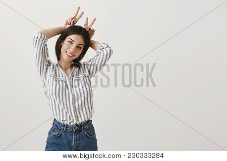 Let Me Be Your Bunny. Portrait Of Cute Stylish Adult Woman In Striped Blouse And Jeans With Trendy J