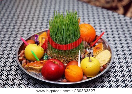 Semeni On Vintage Plate Decorated With Red Cord On National Style Table Cloth . Apple, Candle, Nuts 