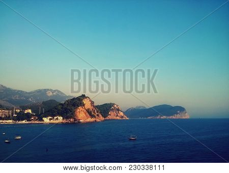 Amazing City Budva Montenegro Europe, Adriatic Sea Island And Mountais. Horizon Adn Reflection. Boat