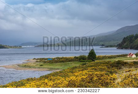 Ullapool, Scotland - June 8, 2012: Looking Over Loch Broom To Ullapool Under Heavy Cloudscape Shows 