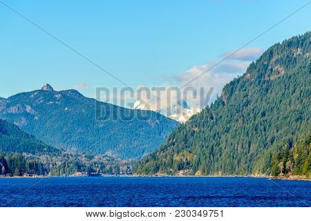 Fantastic view over ocean, snow mountain and rocks at Sechelt inlet in Vancouver, Canada.