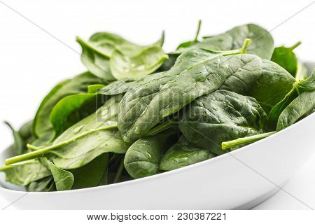 Spinach. Fresh Baby Spinach Leaves In Plate Isolated On White
