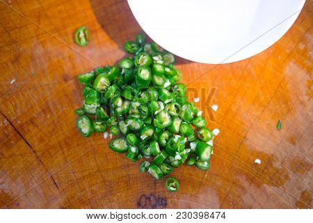 Green Sliced Peppers On A Wooden Cutting Board