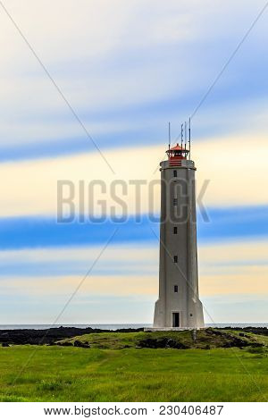 Malariff Lighthouse Tower Standing On The Seashore With Striped Sky In The Background, Western Icela