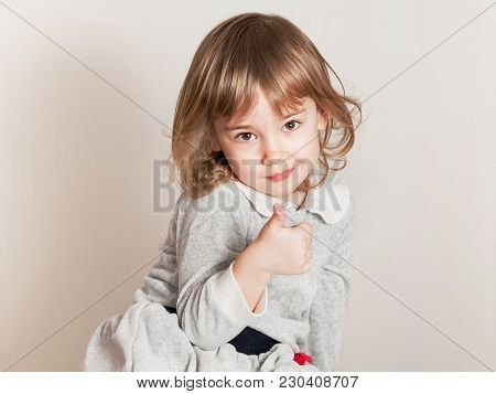 Portrait Of Happy Child Girl With Hands Thumb Up