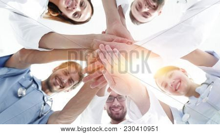bottom view.a team of doctors at the medical center clasped thei