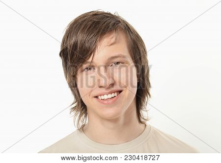 Smiling Young Boy Posing To Camera. Toothy Smile.