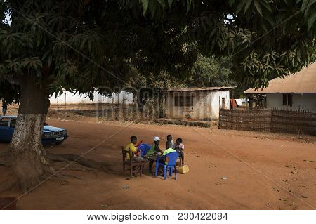Nhacra, Republic Of Guinea-bissau - January 28, 2018: Group Of Children Playing A Game Of Checkers U