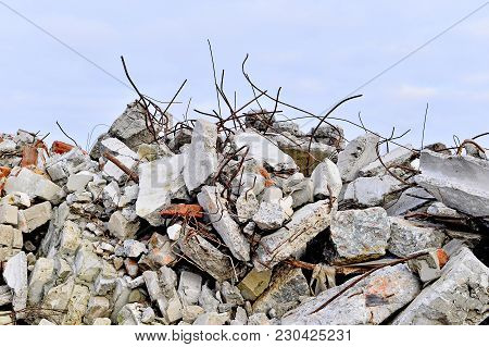 The Rebar Sticking Up From Piles Of Brick Rubble, Stone And Concrete Rubble. Remains Of The Destroye