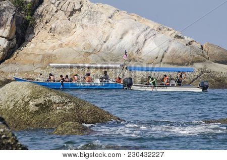 Pangkor Island, Malaysia - 17 December 2017 : Group Of Tourist Enjoy Exploring Pangkor Island Locate