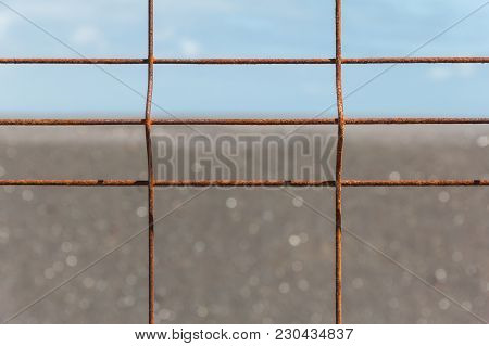 Iron Fence With Corrosion Before Horizon Close-up.