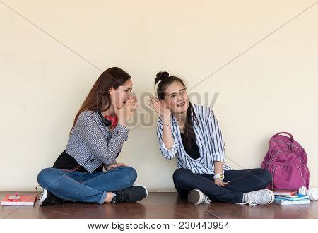 Two Pretty Cuter Teenagers  Sit And Watch Phone To Shares Secrets With Gossip And Entertainment At O