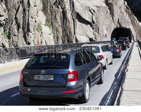 Vehicles On Scenic Teufelsbruecke Devil's Road Bridge And Tunnel In Swiss Alps