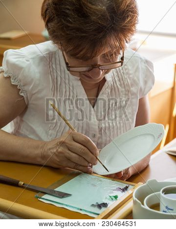 Herend, Veszprem / Hungary - August 03, 2012 - A Herend Porcelain Painter Demonstrates How To Paint 