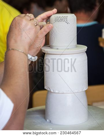 A Porcelain Maker Demonstrates How To Make Her Porcelain Goods At The Factory.
