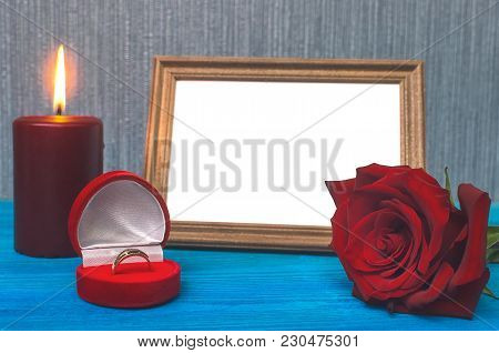 Wedding Ring In A Gift Present Box And Empty Photo Frame Of A Loved One Copy Space And Red Rose Flow