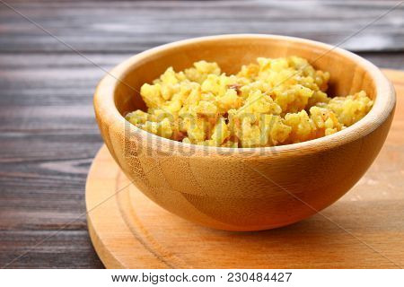 Rice Pilaf With Chicken, Spices And Parsley In A Bowl On A Wooden Table