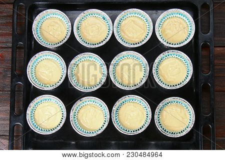 Dough In Molds For Muffins On A Wooden Table