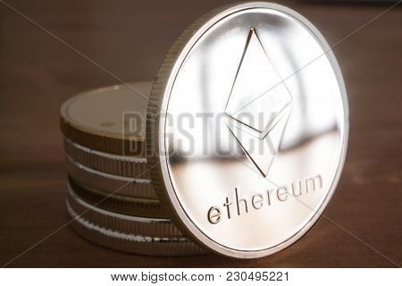 Pile Of Real Coin Of Cryptocurrency Silver Ethereum On Wooden Background