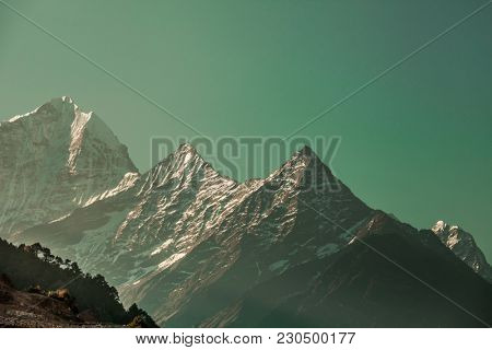 Ideal background in the emerald shade for the different kinds of collages, illustrations and digital media. The Thamserku Mountain, Himalayas. Eastern Nepal.