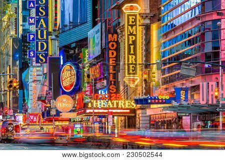 NEW YORK CITY - NOVEMBER 14, 2016: Traffic moves below the illuminated signs of 42nd Street. The landmark street is home to numerous theaters, stores, hotels, restaurants, and attractions.