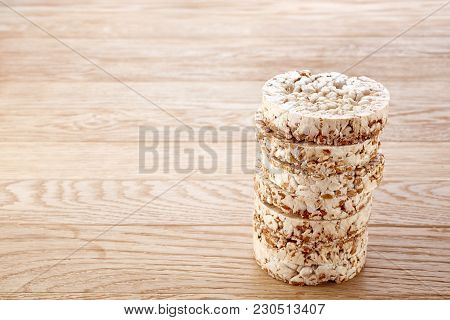 Stack Of Diet Crispbreads On Light Wooden Table, Close-up, Selective Focus. Composition Of Puffed Ri