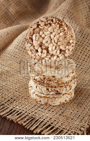 Stack Of Diet Crispbreads On Homespun Napkin Over Light Wooden Table, Close-up, Selective Focus. Com