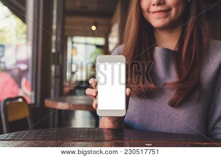 Mockup Image Of A Beautiful Asian Woman Holding And Showing White Mobile Phone With Blank Desktop Sc