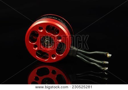 Brushless Motor With Wires Isolated On The Black Reflective Background