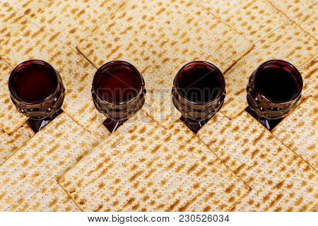 Symbols Of Passover Background. Wine And Matzoh Jewish Holiday Bread Over Wooden Board.
