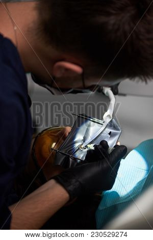 Dentist Making An Injection To A Patient With A Rubberdam