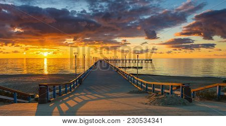Colorful Sunset At A Famous Marine Pier In The Baltic Resort City Of Palanga, Lithuania, Europe