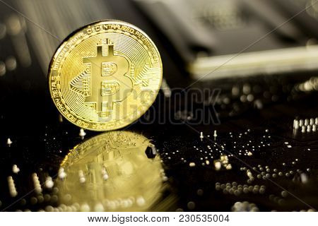 Bitcoin Coin On The Back Of A Pc Motherboard, Symbolizing It's A Virtual Money.